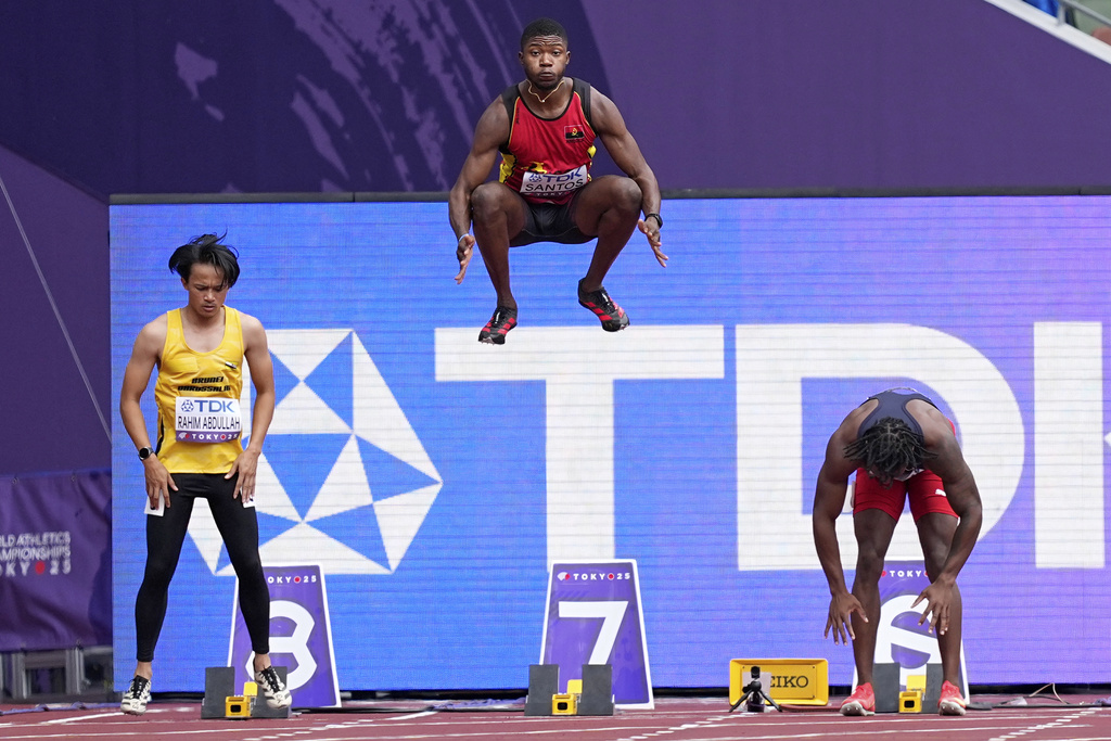 Angola's Marcos Santos leaps into the air as he warms-up for a men's 100 meters preliminary round heat at the World Athletics Championships in Tokyo, Saturday, Sept. 13, 2025. (AP Photo/Petr David Josek)