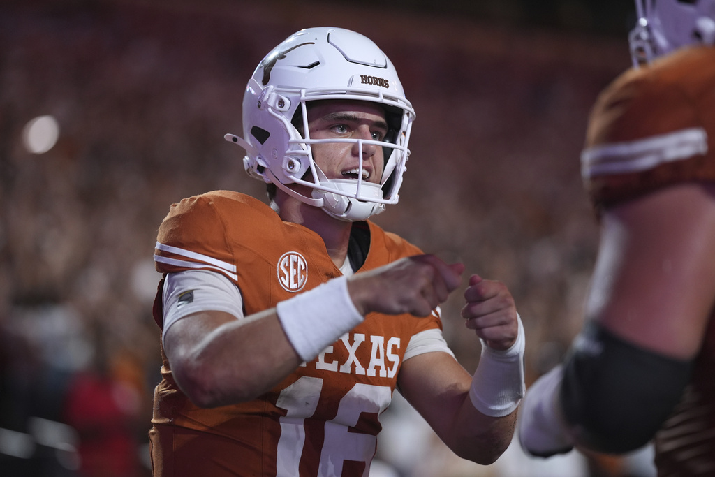 Texas quarterback Arch Manning (16) celebrates with teammates after he scored a touchdown against Sam Houston State during the first half of an NCAA college football game in Austin, Texas, Saturday, Sept. 20, 2025. (AP Photo/Eric Gay)