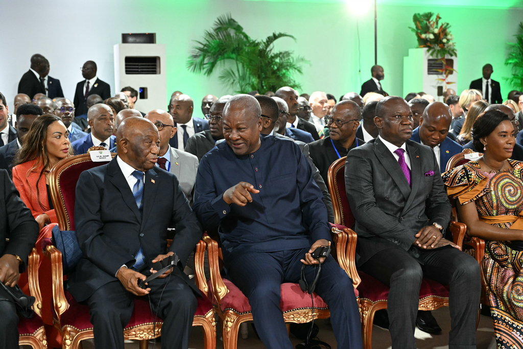 Liberia's President Joseph Nyuma Boakai, left, speaks to Ghana's President John Dramani Mahama, center, as Gabon's President Brice Clotaire Oligui Nguema, right, looks on at the Presidential Palace during the inauguration ceremony of President Alassane Ouattara in Abidjan, Ivory Coast, Monday, Dec. 8, 2025. (Sia Kambou/Pool Photo via AP)