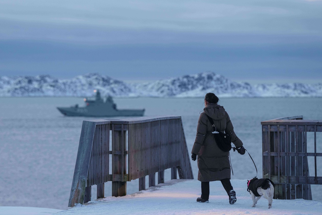 A woman walks with her dog in Nuuk, Greenland, on Thursday, Jan. 15, 2026. (AP Photo/Evgeniy Maloletka)