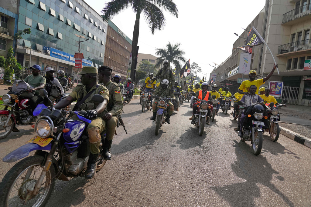 Uganda's security forces patrol a street as supporters of Ugandan President Yoweri Museveni celebrate his victory in the presidential election in Kampala, Uganda, Saturday, Jan. 17, 2026. (AP Photo/Brian Inganga)