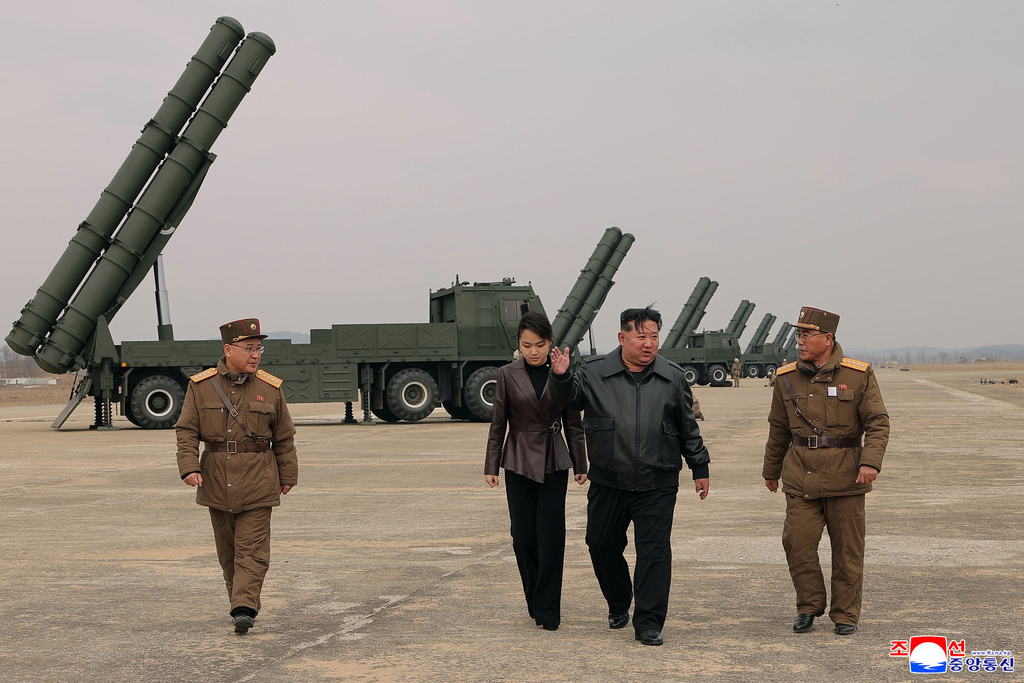 In this photo provided by the North Korean government, its leader Kim Jong Un, center right, and his daughter, center left, attend a live-fire test of multiple rocket launch systems, at an undisclosed place in North Korea Saturday, March 14, 2026. Independent journalists were not given access to cover the event depicted in this image distributed by the North Korean government. The content of this image is as provided and cannot be independently verified. Korean language watermark on image as provided by source reads: "KCNA" which is the abbreviation for Korean Central News Agency. (Korean Central News Agency/Korea News Service via AP)