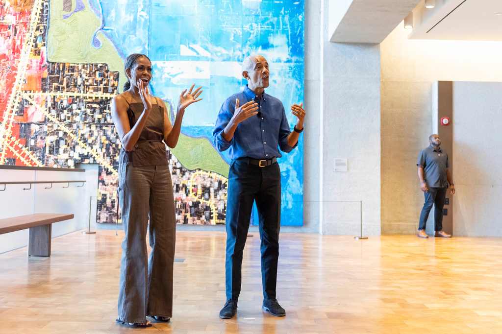 Former President Barack Obama and former first lady Michelle Obama welcome community members in the Hope and Change lobby before they walk through the museum at the Obama Presidential Center in Chicago on Friday, June 19, 2026. (Eileen T. Meslar/Chicago Tribune via AP, Pool)