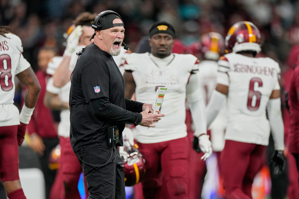 Washington Commanders head coach Dan Quinn celebrates after his team stopped a Miami Dolphins drive during the second half of an NFL football game between the Washington Commanders and the Miami Dolphins in Madrid, Spain, Sunday, Nov. 16, 2025.(AP Photo/Bernat Armangue)