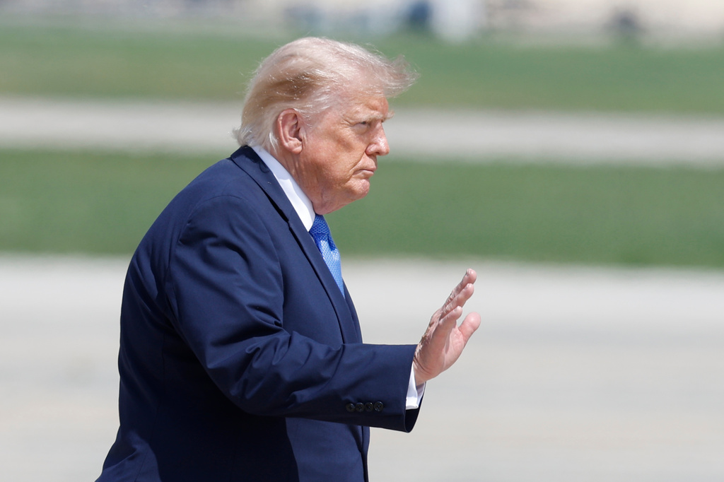 President Donald Trump waves as he walks from Marine One to Air Force One, at Joint Base Andrews, Md., Tuesday, Aug. 4, 2026. (AP Photo/Luis M. Alvarez)