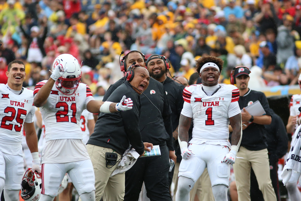 Utah players react during the second half of an NCAA college football game against West Virginia, Saturday, Sept, 27, 2025, in Morgantown, W.Va. (AP Photo/ William Wotring)