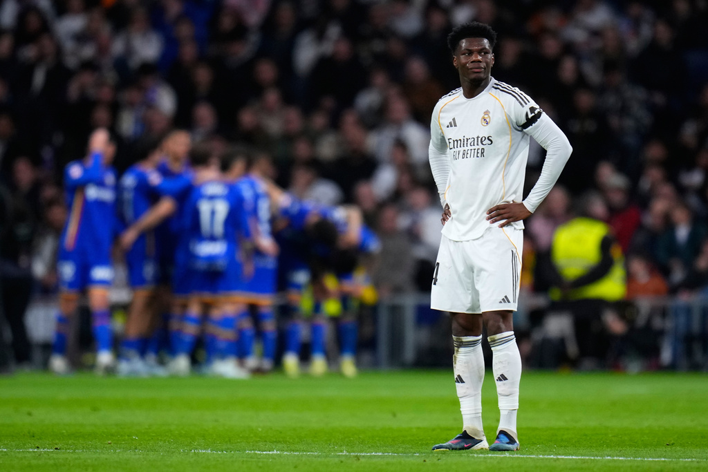 Real Madrid's Aurelien Tchouameni stands as Getafe's Satriano celebrates with team mates the opening goal during a Spanish La Liga soccer match between Real Madrid and Getafe in Madrid, Spain, Monday, March 2, 2026. (AP Photo/Manu Fernandez)