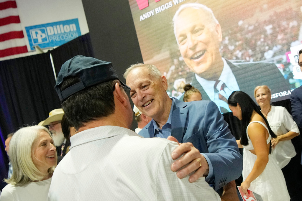 Arizona Republican gubernatorial candidate U.S. Rep. Andy Biggs, right, greets a supporter after being declared the winner in the primary, Tuesday, July 21, 2026, in Scottsdale, Ariz. (AP Photo/Ross D. Franklin)