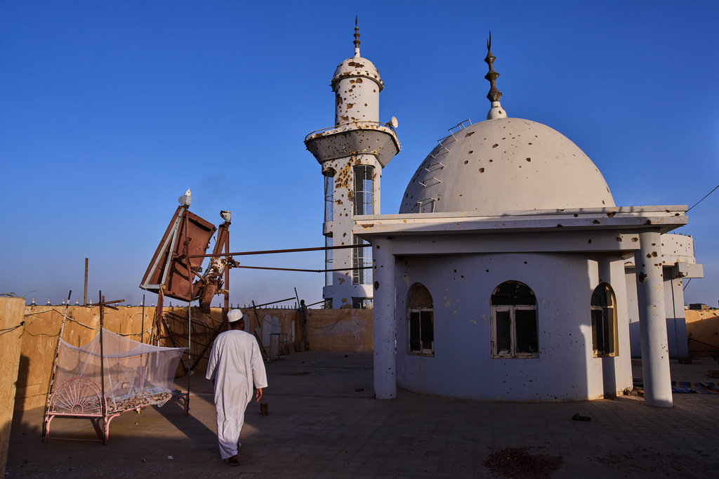 A man walks on the rooftop of the Sheikh GaribAllah Mosque damaged during the war in Omdurman, Sudan, on the outskirts of Khartoum, Friday, April 17, 2026. (AP Photo/Bernat Armangue)