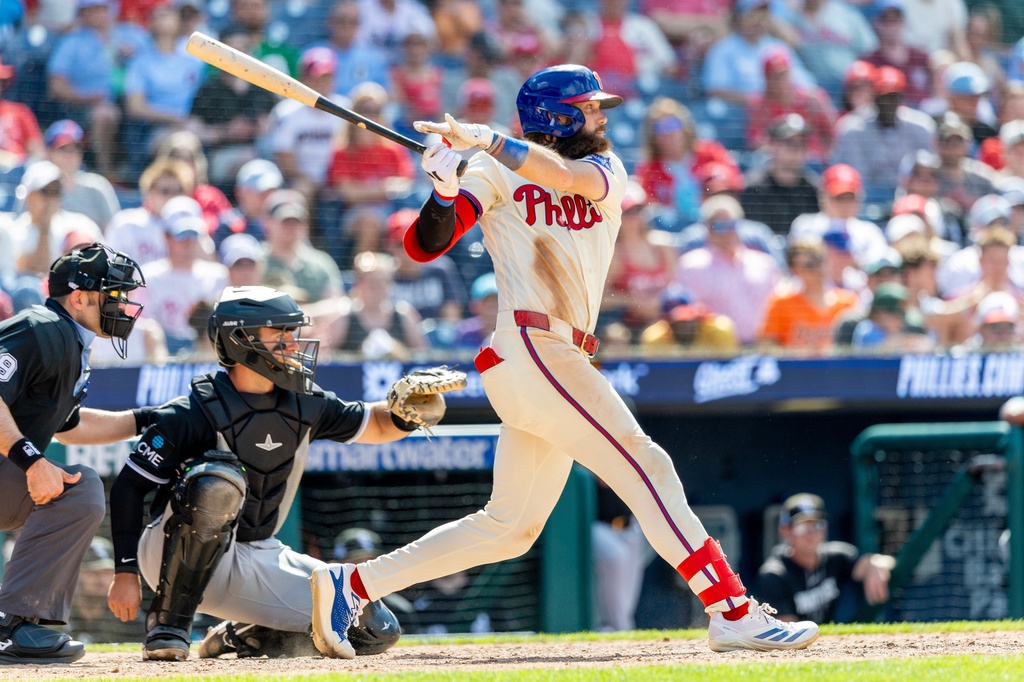 Philadelphia Phillies' Brandon Marsh, right, hits an RBI single in the sixth inning of a baseball game against the Chicago White Sox, Sunday, June 7, 2026, in Philadelphia. (AP Photo/Laurence Kesterson)