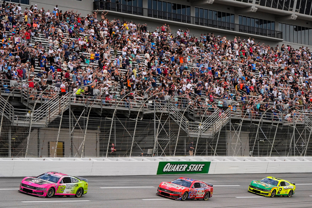 Ryan Blaney, Joey Logano, and Austin Cindric, from left, run during a NASCAR Cup Series auto race, Sunday, July 12, 2026, in Hampton, Ga. (AP Photo/Mike Stewart)