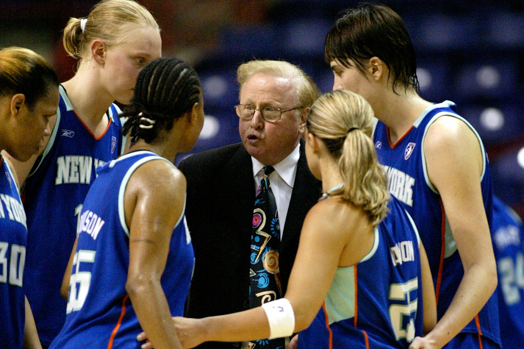 FILE - New York Liberty coach Richie Adubato, center, gives his team instructions in the closing minute of an WNBA basketball game against the Seattle Storm in Spokane, Wash., June 26, 2004. (AP Photo/Jeff T. Green, File)