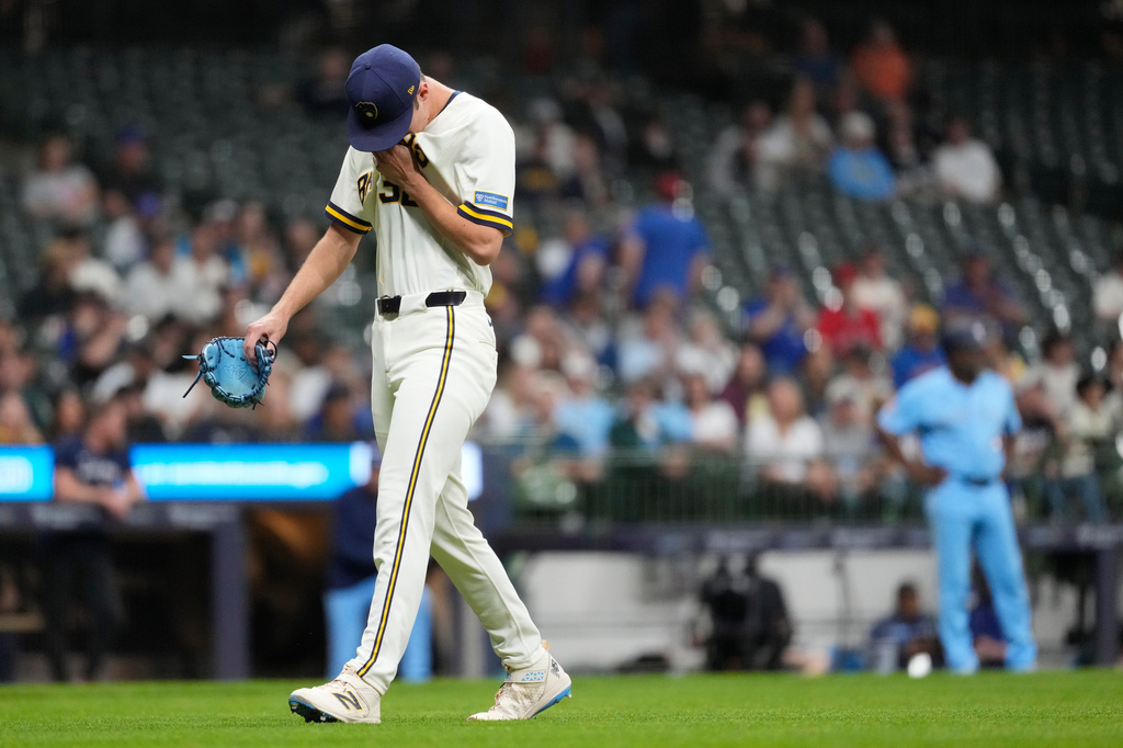 Milwaukee Brewers' Jacob Misiorowski wipes his face as he walks to the dugout after being removed during the sixth inning of a baseball game against the Toronto Blue Jays, Tuesday, April 14, 2026, in Milwaukee. (AP Photo/Aaron Gash)