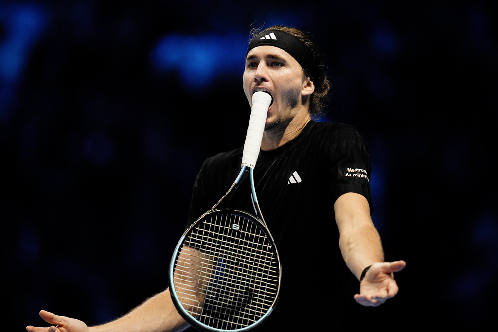 Germany's Alexander Zverev bites the end of his racket during a tennis match against Italy's Jannik Sinner at the ATP World Tour Finals, in Turin, Italy, Wednesday, Nov. 12, 2025. (Marco Alpozzi/LaPresse via AP)