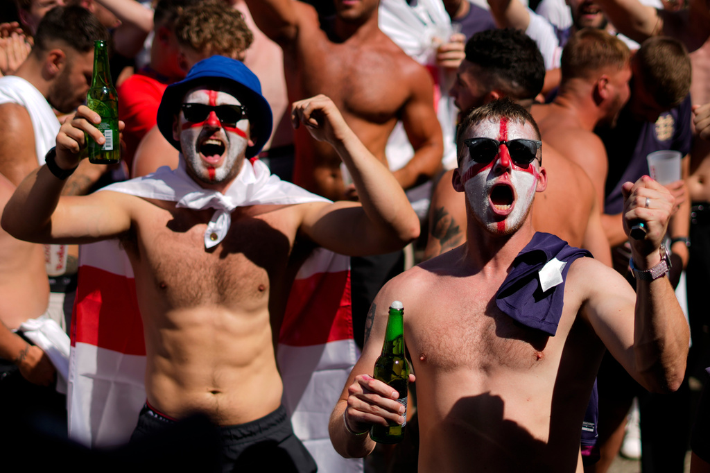 FILE - Men with face painted in the colors on the England flag chant slogans and drink beers at Breitscheidplatz before the start of the final match between Spain and England at the Euro 2024 soccer tournament in Berlin, Germany, July 14, 2024. (AP Photo/Ariel Schalit, File)