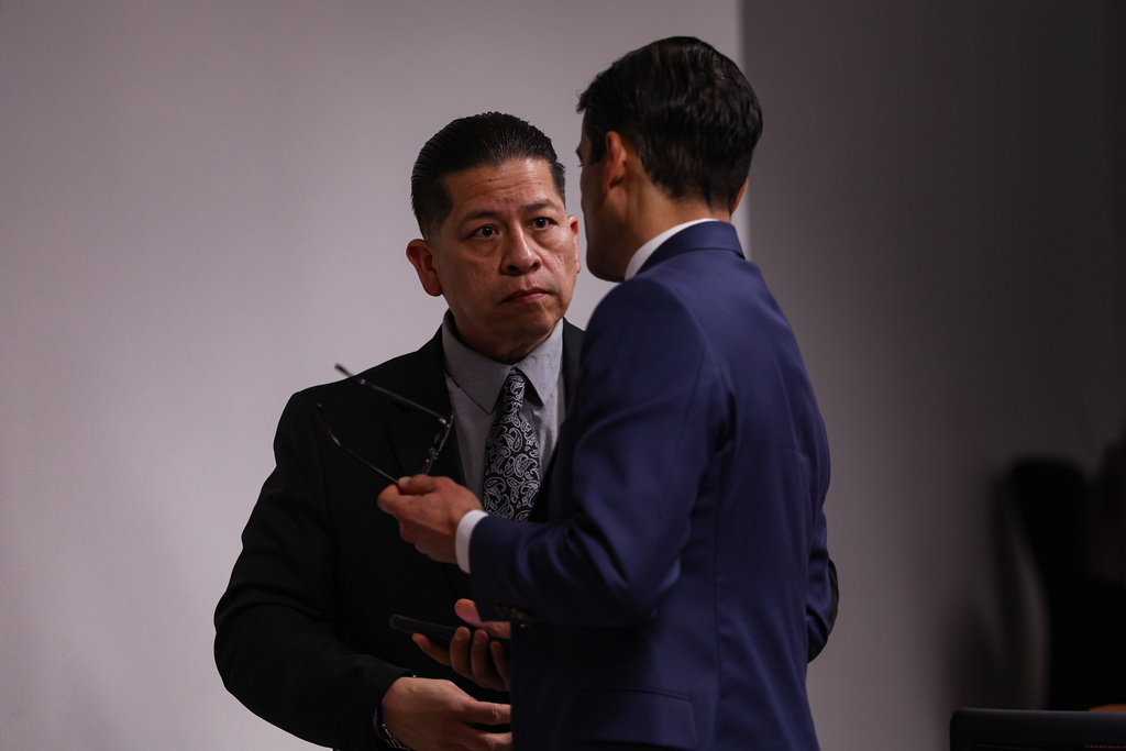 Former Uvalde school district police officer Adrian Gonzales, left, talks to his defense attorney Nico LaHood during a break on the 10th day of his trial at Nueces County Courthouse in Corpus Christi, Texas, Tuesday, Jan. 20, 2026. (Sam Owens/The San Antonio Express-News via AP, Pool)