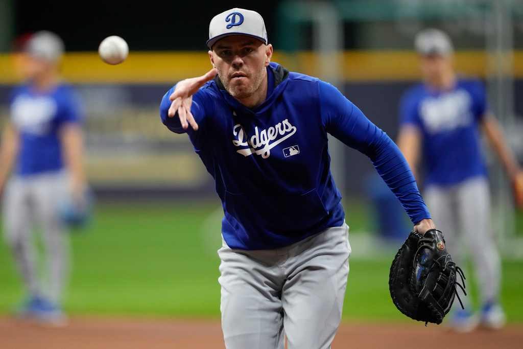 Los Angeles Dodgers first baseman Freddie Freeman tosses a ball during batting practice ahead of Game 1 of baseball's National League Championship Series between the Milwaukee Brewers and the Los Angeles Dodgers on Sunday, Oct. 12, 2025, in Milwaukee. (AP Photo/Ashley Landis)