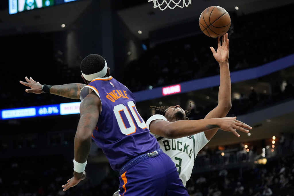 Milwaukee Bucks' Myles Turner (3) is fouled as he shoots against Phoenix Suns' Royce O'Neale during the first half of an NBA basketball game Tuesday, March 10, 2026, in Milwaukee. (AP Photo/Aaron Gash)