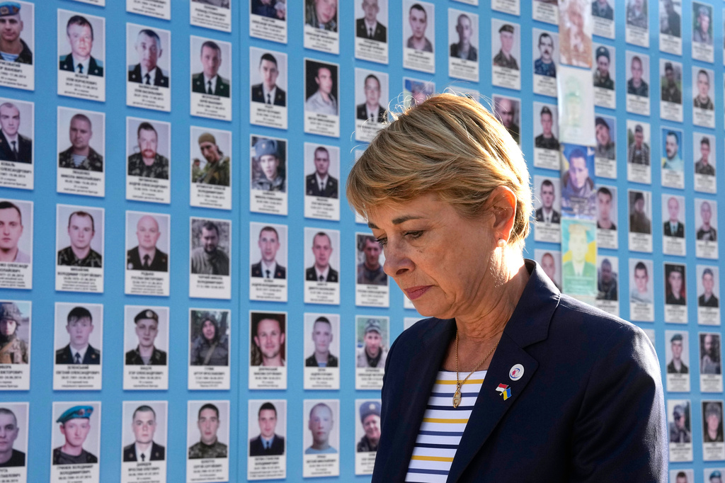 Monaco's Foreign Minister Isabelle Berro-Amadei walks past the Memory Wall of Fallen Defenders of Ukraine in Kyiv, Ukraine, Tuesday, Sept. 15, 2026. (AP Photo/Efrem Lukatsky)