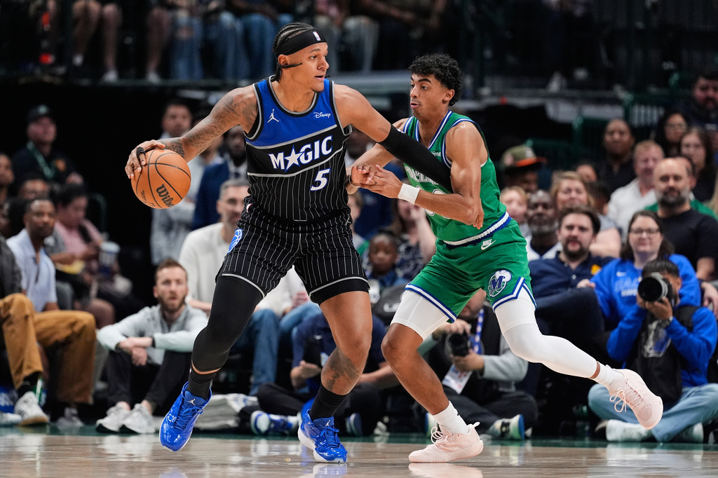 Orlando Magic forward Paolo Banchero (5) works to the basket against Dallas Mavericks' Max Christie, right, in the first half of an NBA basketball game Friday, April 3, 2026, in Dallas. (AP Photo/Tony Gutierrez)