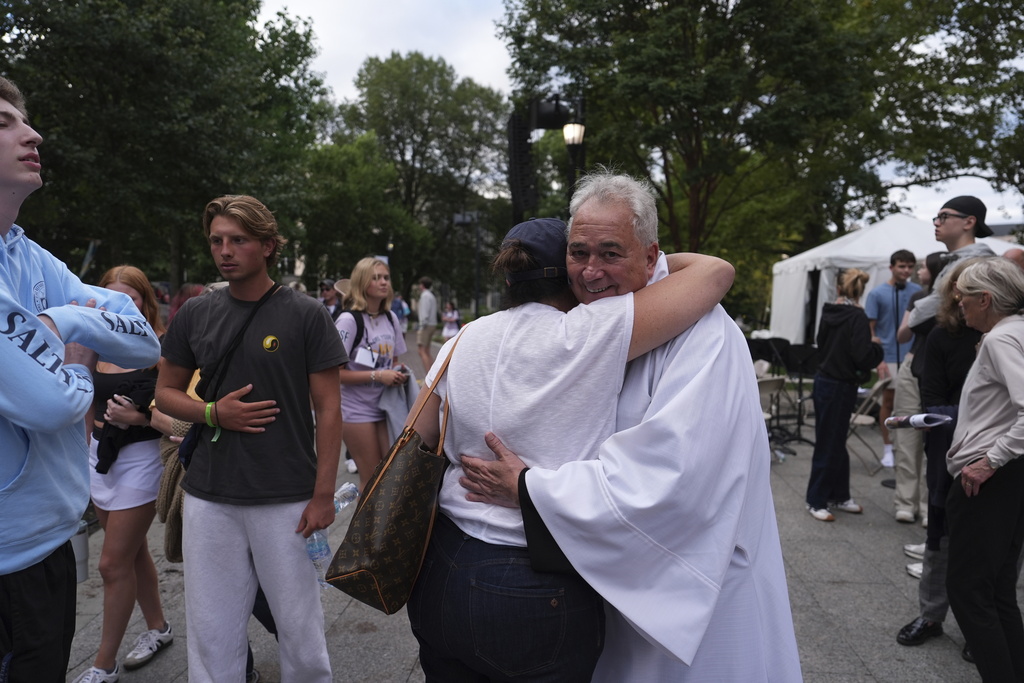 Villanova University President Father Peter M. Donohue comforts after an active shooter was reported Thursday, Aug. 21, 2025, in Villanova, Pa. (AP Photo/Matt Slocum)
