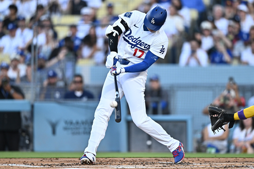 Los Angeles Dodgers' Shohei Ohtani hits a home run during the first inning of a baseball game against the Arizona Diamondbacks, Friday, July 10, 2026, in Los Angeles. (AP Photo/William Liang)