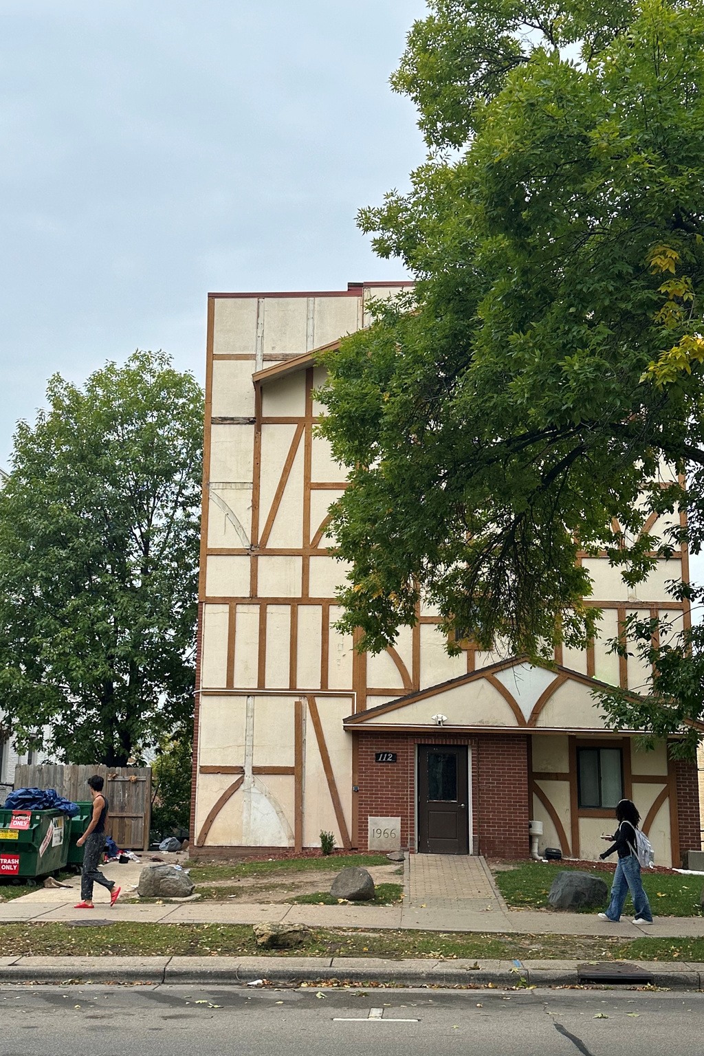 People walk by the Alpha Epsilon Pi fraternity house located near the University of Wisconsin-Madison campus, where police say they investigated a hazing incident, on Friday, Sept. 25, 2026, in Madison, Wis. (AP Photo/Scott Bauer).