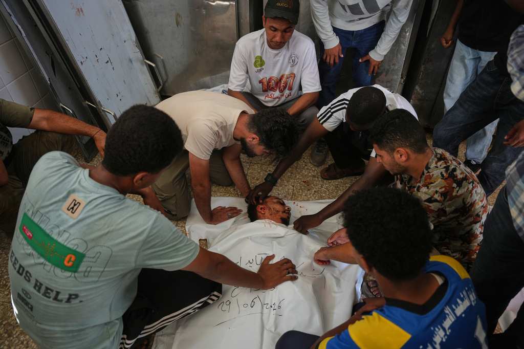 Palestinians mourn over the body of Ali Asbitan, 28, who was killed in an Israeli airstrike during his funeral at Al-Aqsa Hospital in Deir al-Balah, Gaza Strip, Monday, June 29, 2026. (AP Photo/Abdel Kareem Hana)