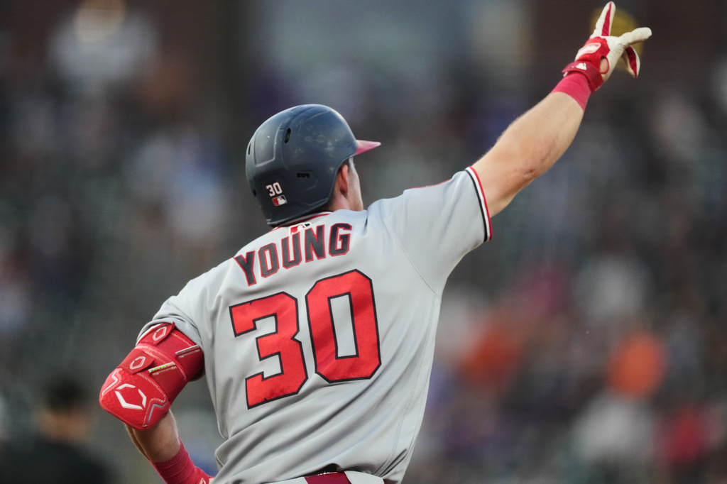 Washington Nationals' Jacob Young gestures to the bullpen as he circles the bases after hitting a solo home run off Colorado Rockies starting pitcher Kyle Freeland in the sixth inning of a baseball game Monday, July 20, 2026, in Denver. (AP Photo/David Zalubowski)