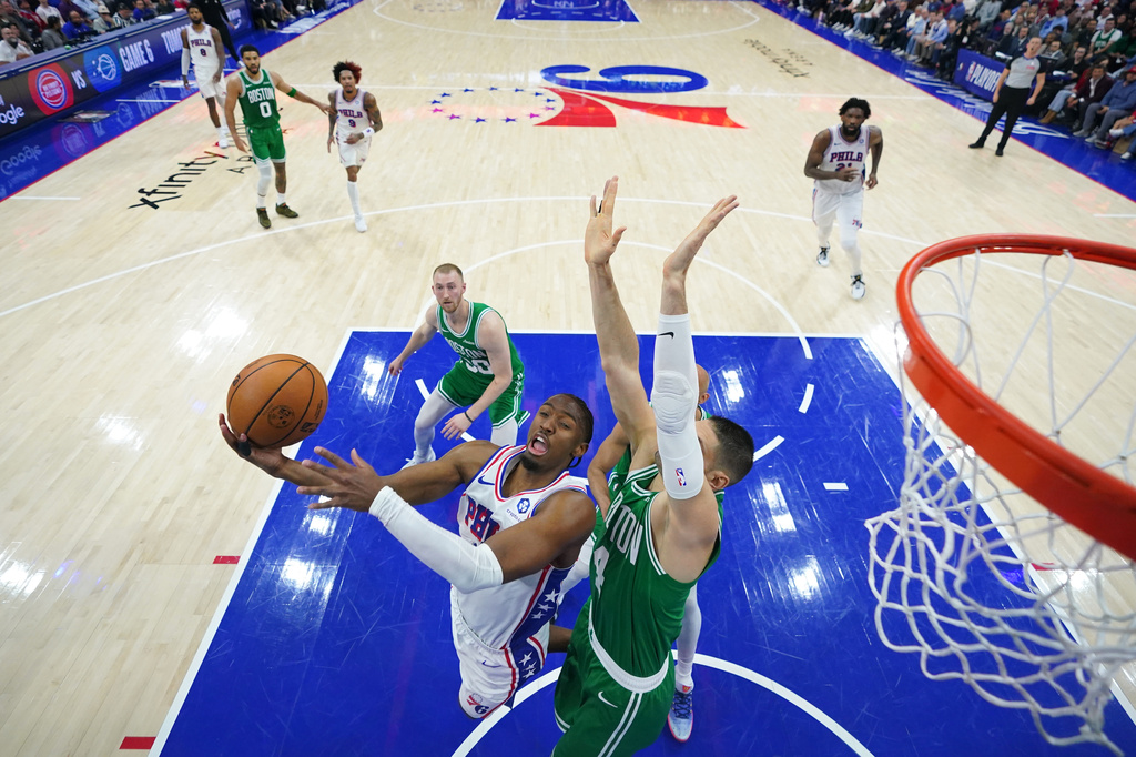 Philadelphia 76ers' Tyrese Maxey, left, goes up for a shot against Boston Celtics' Nikola Vucevic during the first half of Game 6 in a first-round NBA basketball playoff series Thursday, April 30, 2026, in Philadelphia. (AP Photo/Matt Slocum)