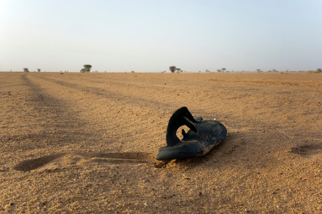FILE - A sandal lies on the ground in Niger's desert region of the south central Sahara, Sunday, June 3, 2018. (AP Photo/Jerome Delay, File)