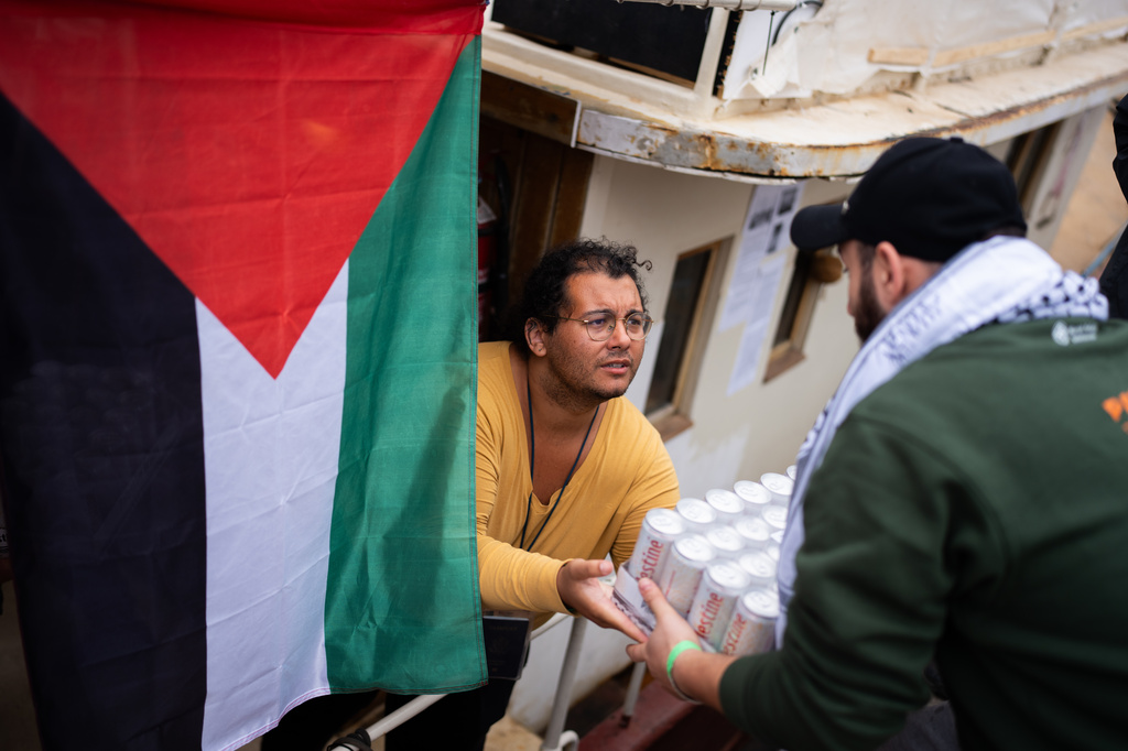 Activists prepare supplies aboard a boat taking part in the Global Sumud Flotilla destined for Gaza, in Barcelona, Spain, Sunday, April 12, 2026. (AP Photo/Joan Mateu Parra)
