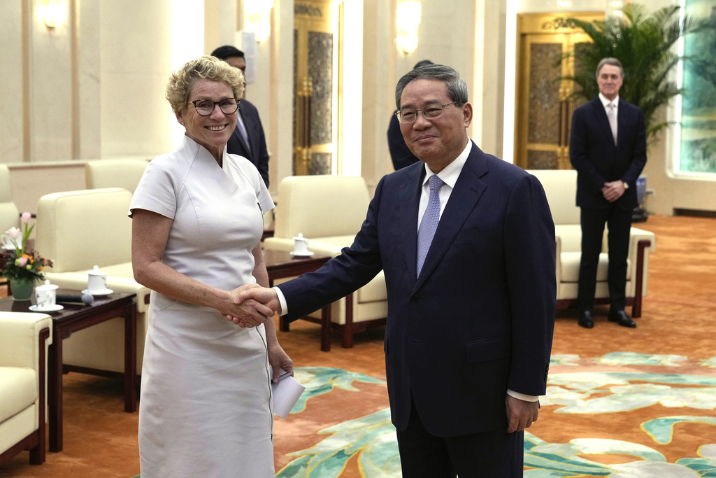 Chrissy Houlahan, Democratic member of House Armed Services Committee, left, poses for a photo with Chinese Premier Li Qiang at the Great Hall of the People in Beijing, China, Sunday, Sept. 21, 2025. (AP Photo/Mahesh Kumar A., Pool)
