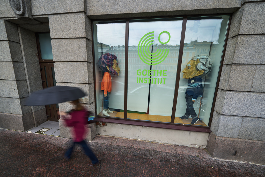 A person walks past figures depicting Johann Wolfgang Goethe, right, and Russian poet Alexander Pushkin installed in the window of the Goethe-Institut, Germany's cultural center in St. Petersburg, Russia, Thursday, Sept. 3, 2026. (AP Photo/Dmitri Lovetsky)