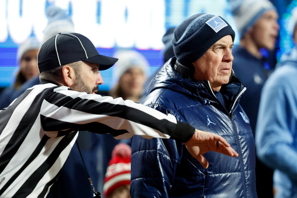 North Carolina head coach Bill Belichick talks with an official during the first half of an NCAA college football game against North Carolina State in Raleigh, N.C., Saturday, Nov. 29, 2025. (AP Photo/Karl DeBlaker)