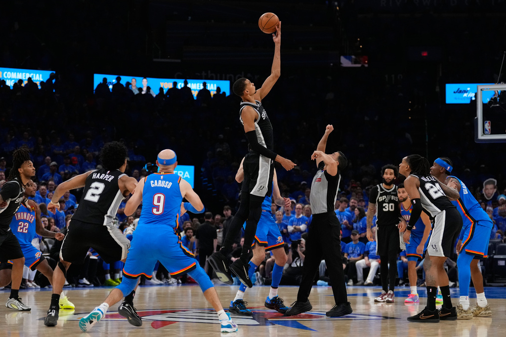 San Antonio Spurs forward Victor Wembanyama (1) tips off during overtime of Game 1 in a third-round NBA basketball playoffs series against the Oklahoma City Thunder Monday, May 18, 2026, in Oklahoma City. (AP Photo/Tony Gutierrez)