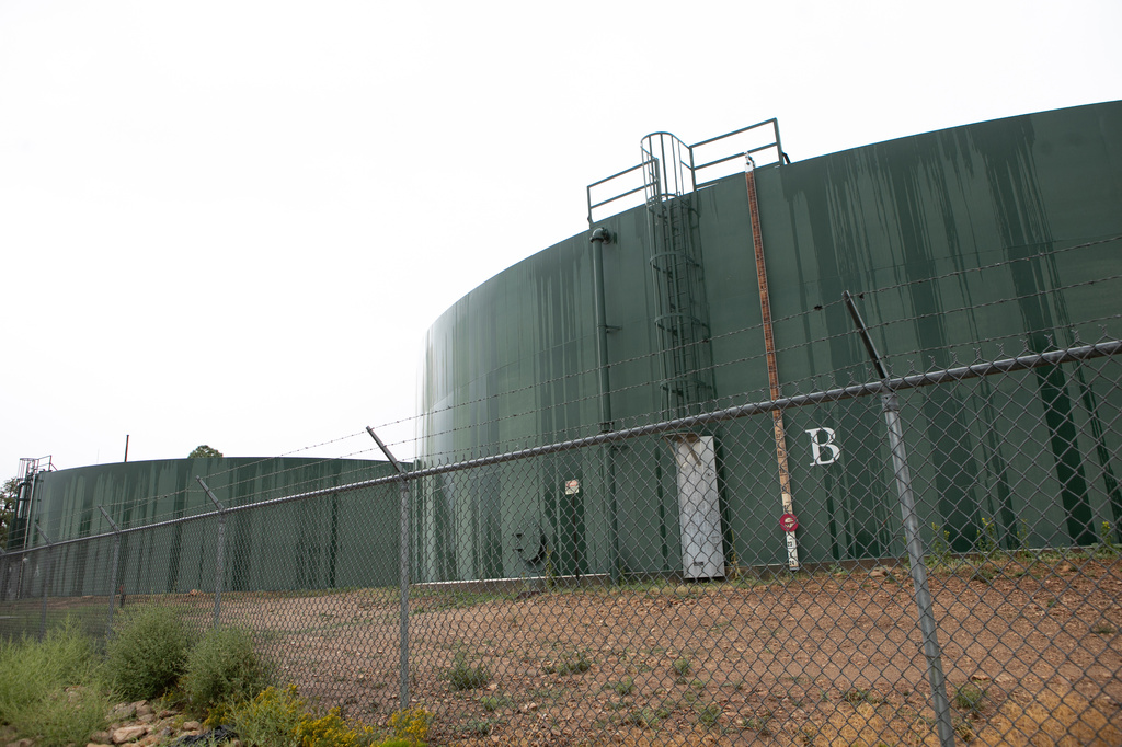 Reserve water tanks for holding drinking water for Grand Canyon Village stand behind fencing, Monday, Aug. 31, 2026, in Grand Canyon National Park, Ariz. (AP Photo/Josh Biggs)