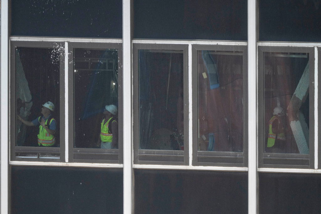 People inspect buckled support beams inside 235 East 42nd Street, Wednesday, July 8, 2026, in New York. (AP Photo/Yuki Iwamura)