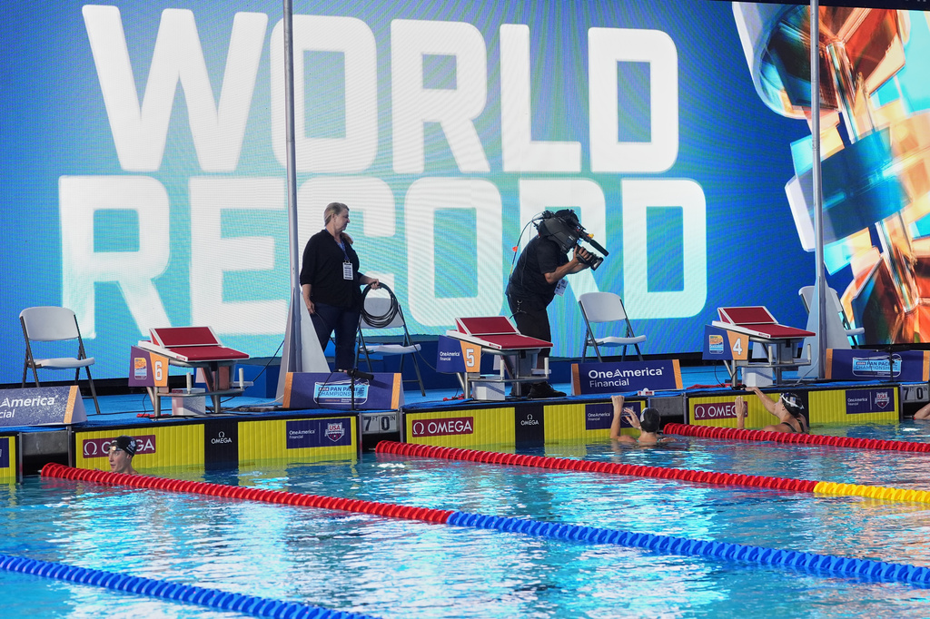 Kate Douglass, of the United States, right, gets out of the pool after winning the women's 50 meters freestyle final with a new world record at the Pan Pacific Swimming Championships Saturday, Aug. 15, 2026 in Irvine, Calif. (AP Photo/Gregory Bull)