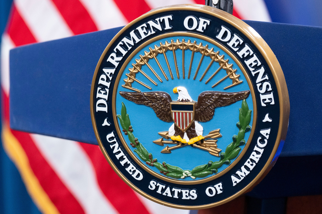 FILE - The Department of Defense seal is seen on the podium in the Press Briefing room at the Pentagon, Oct. 29, 2024, in Washington. (AP Photo/Kevin Wolf, File)