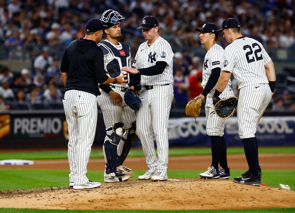 New York Yankees'manager Aaron Boone takes the ball from New York Yankees pitcher Ryan Weathers during the seventh inning of a baseball game against the Chicago White Sox, Thursday, June 18, 2026, in New York. (AP Photo/Noah K. Murray)