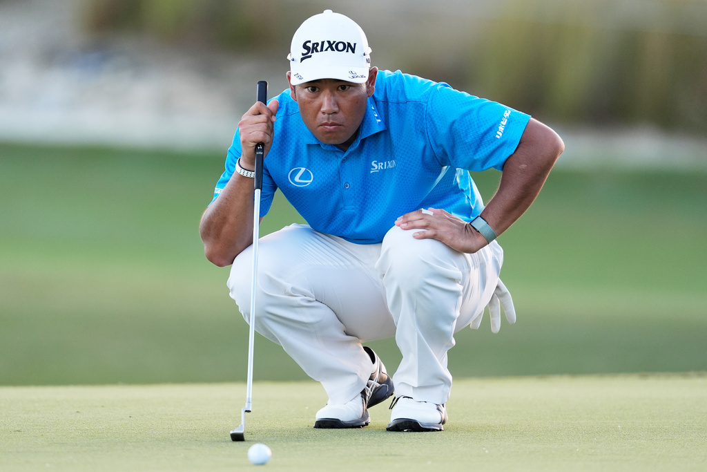 Hideki Matsuyama, of Japan, studies his putt on the 18th hole during the third round of the Hero World Challenge PGA Tour at Albany Golf Club in New Providence, Bahamas, Saturday, Dec. 6, 2025. (AP Photo/Fernando Llano)