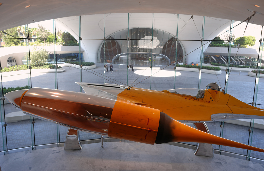 A Naboo N-1 Starfighter from the film "Star Wars: Episode I - The Phantom Menace" is suspended above the entrance to the Education Lobby of the Lucas Museum of Narrative Art during a preview on Monday, Aug. 31, 2026, in Los Angeles. (AP Photo/Chris Pizzello)