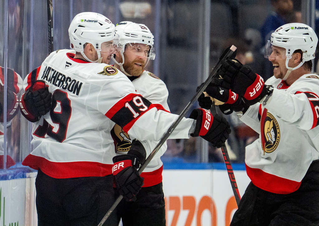 Ottawa Senators right wing Drake Batherson (19) is congratulated by right winger Claude Giroux (28) and defenseman Thomas Chabot (72) after scoring during the second period of an NHL hockey game in Toronto, Saturday, Feb 28, 2026. (Frank Gunn/The Canadian Press via AP)