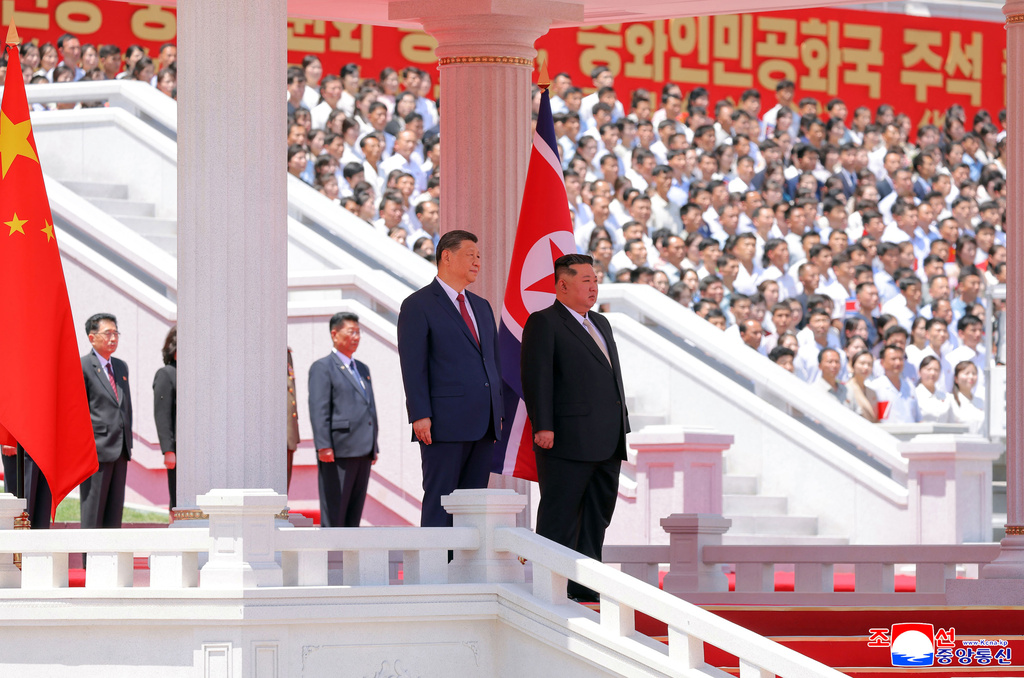 In this photo provided by the North Korean government, North Korean leader Kim Jong Un, center right, and Chinese President Xi Jinping, center left, attend a welcome ceremony in Pyongyang, Monday, June 8, 2026. Independent journalists were not given access to cover the event depicted in this image distributed by the North Korean government. The content of this image is as provided and cannot be independently verified. Korean language watermark on image as provided by source reads: "KCNA" which is the abbreviation for Korean Central News Agency. (Korean Central News Agency/Korea News Service via AP)