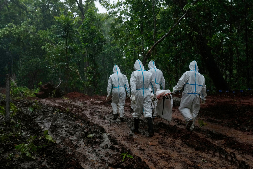 Nepal's paramilitary force personnel carry the body of a flash flood victim for burial at a mass burial site in Chitwan, Nepal, Monday, Aug. 31, 2026. (AP Photo/Dar Yasin)