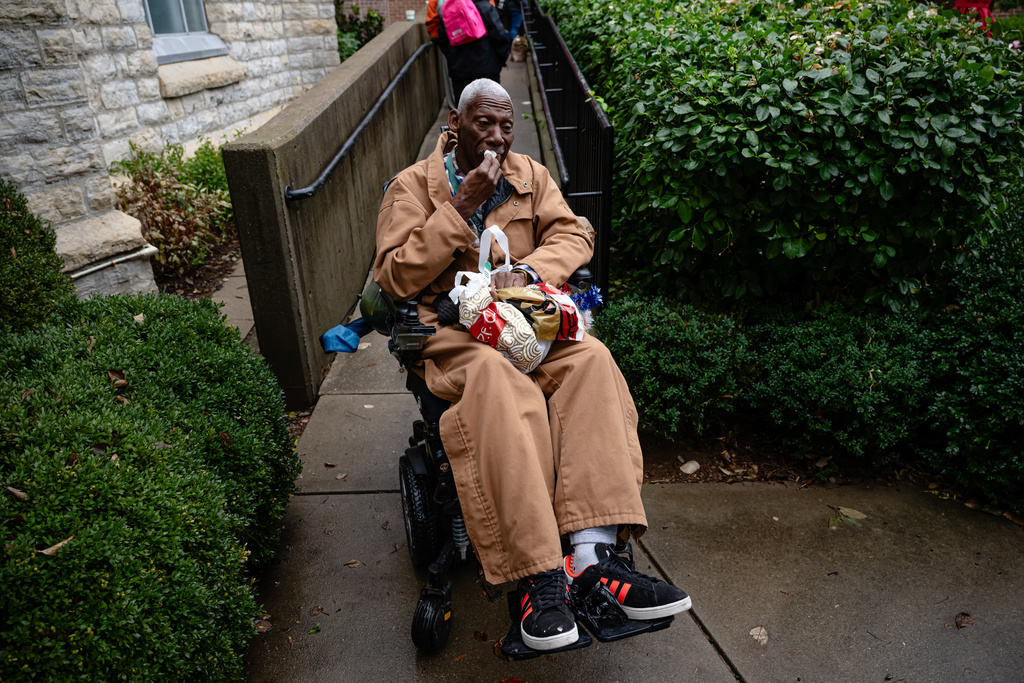 Brock Brooks, a disable Marine Corps veteran, cries while describing the impending SNAP shutdowns while waiting in line to enter the food pantry service at Calvary Episcopal Church on Thursday, Oct. 30, 2025, in Louisville, Ky. (AP Photo/Jon Cherry)