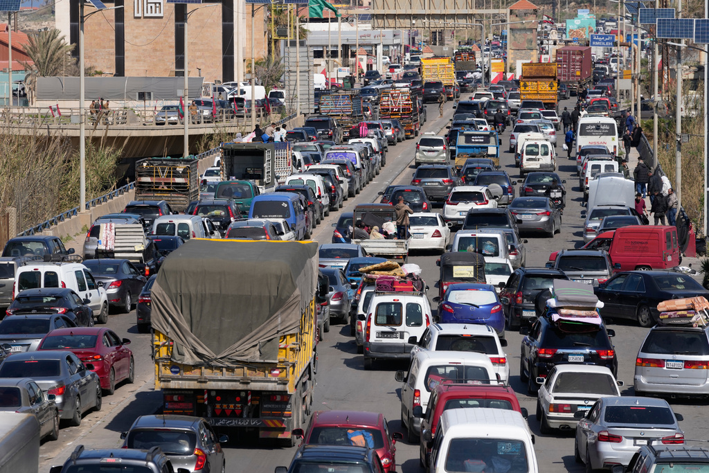Displaced civilians fleeing Israeli airstrikes in southern Lebanon, sit in traffic along a highway toward Beirut, in the southern port city of Sidon, Lebanon, Tuesday, March 3, 2026. (AP Photo/Mohammed Zaatari)