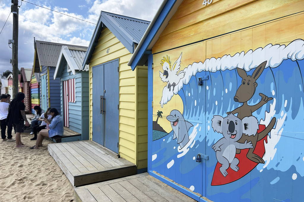 Visitors take photos by the Bathing boxes at Brighton Beach in Melbourne, Australia, Saturday, Sept. 13, 2025. (AP Photo Rod McGuirk)
