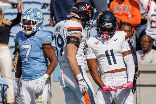 Virginia's Trell Harris (11) celebrates with John Rogers (89) after scoring a touchdown as North Carolina's Khmori House (7) looks away during the first half of an NCAA college football game in Chapel Hill, N.C., Saturday, Oct. 25, 2025. (AP Photo/Ben McKeown) Virginia's Trell Harris (11) celebrates with John Rogers (89) after scoring a touchdown as North Carolina's Khmori House (7) looks away during the first half of an NCAA college football game in Chapel Hill, N.C., Saturday, Oct. 25, 2025. (AP Photo/Ben McKeown)